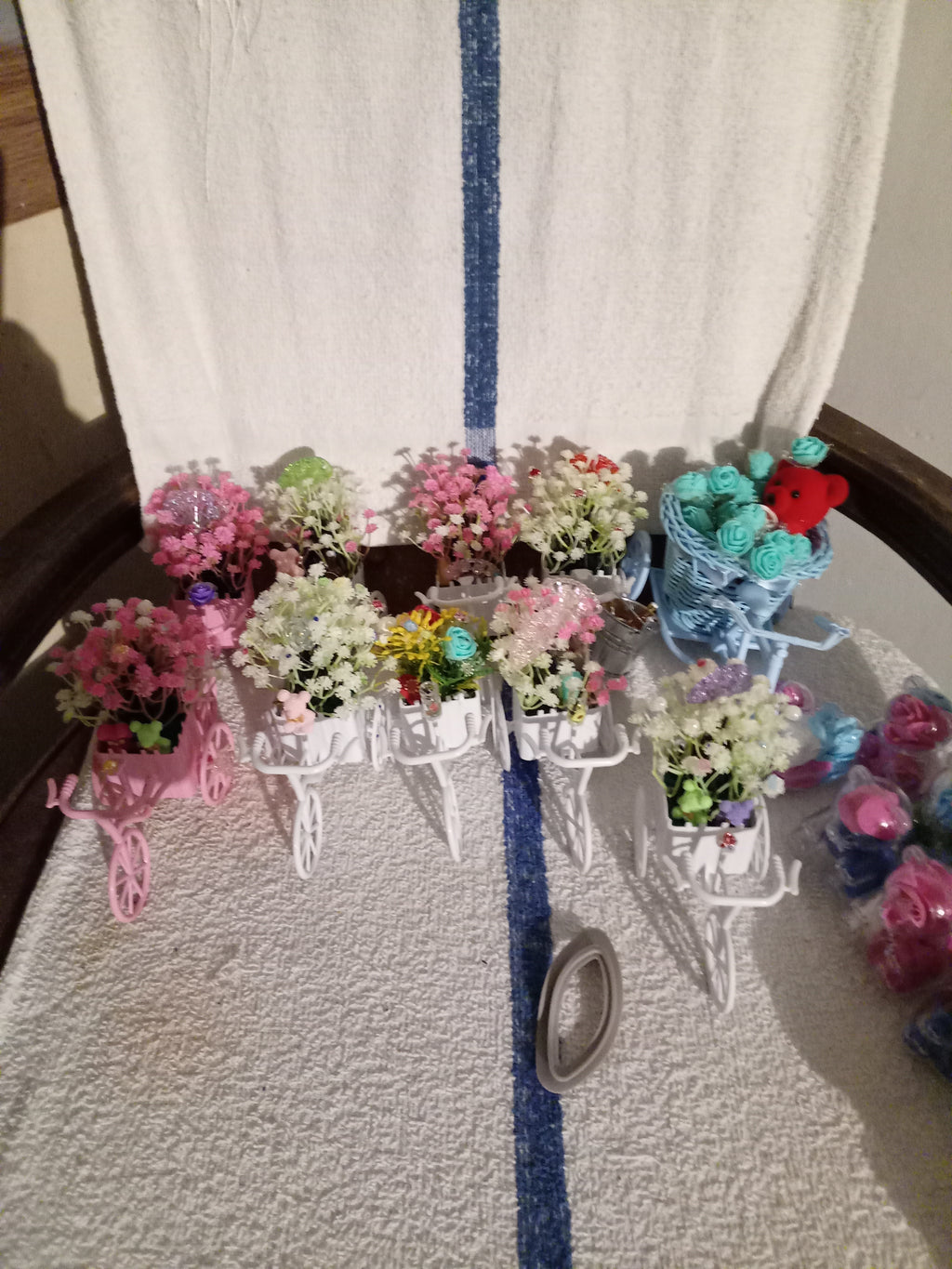 Blue bicycle planter with teal roses and red teddy bear - side view