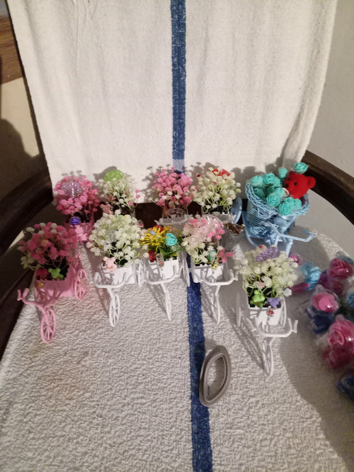 Blue bicycle planter with teal roses and red teddy bear - side view