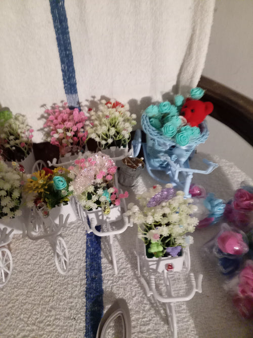 Blue bicycle planter with teal roses and red teddy bear - front view